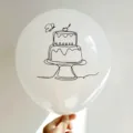 Close-up of a white latex balloon with a black line art cake print design. - 白色印蛋糕款