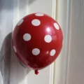 Red thick latex balloon with white polka dot pattern for birthdays and party decorations. - Red Polka Dot Style