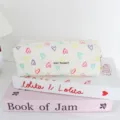 Detailed view of a cute pleated foam pencil case with colorful hearts and zipper closure. - Colorful Hearts