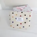 Detail view of the cute corduroy cosmetic bag with colorful heart prints and a woven label. - Small Storage Bag / Colorful Heart Lipstick Bag