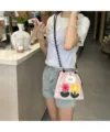 Detailed view of the pink canvas phone bag with cute embroidered flowers and drawstring closure. - Pink