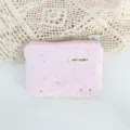 Closeup detail of pink canvas pouch featuring sparkling silver stars and cute zipper. - Pink