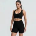 Close-up detail of the black ribbed yoga set featuring a supportive sports bra and active shorts. - S / Top And Bottom / Black