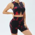 Close up view of the black and red tie-dye athletic crop top with front zipper and matching shorts. - Black Red