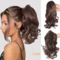 Detailed view of wavy claw clip ponytail extension showing natural hair texture and clip. - 2/30 Style