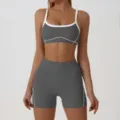 Close-up detail of women athletic sports bra and high waist fitness shorts set in dark grey. - M / Set / Dark Gray