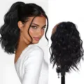 Black wavy ponytail wig detail view showing natural cloud perm curls and secure rubber band. - Natural Black