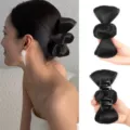 Black bow hair claw clip detail shot showing synthetic hair bun extension and sturdy claw. - Natural Black