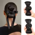 Close-up detail showing the black hair bun claw clip with bow, highlighting back wear and design. - Calico