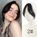 French bangs hair topper detail presentation, natural black clip-in fringe hair piece close-up. - Natural Black