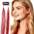 Closeup of red hair tinsel extensions with clip, sparkling synthetic strands for party styling. - Red