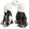 Detail view of the knitted beanie with long wavy synthetic wig, showing fox embroidery and inner lining. - White Fox Hat (Cool Brown + Mist Blue Highlight)