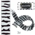 Clip-in hair extension detail showing secure metal comb clip and black white animal print. - Light Gray Textured