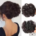 Close-up detail of messy curly hair bun extension with secure claw clip for easy styling. - Red Brown
