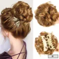 Detail view of synthetic curly hair claw clip bun, showing fluffy messy updo texture and clip. - Gold