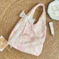 Pink tie-dye canvas shoulder bag featuring cute lace embroidery and bow detail view. - Pink + White Floral