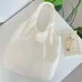 Korean style floral embroidered hollow texture hobo bag detail shot, elegant fabric tote bag. - Vest Shoulder Bag / Hollow Floral