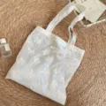 Sheer floral embroidered tote bag detail, lightweight organza fabric, elegant everyday carry. - Shoulder Bag