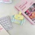Detail shot of the cute plaid storage pouch featuring a snap button and hanging loop design. - Blue Grid