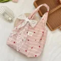 Detailed view of cute pink striped tote bag with white lace bow and heart embroidery. - Red Heart Stripe + White Flower Accessory
