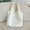 Detailed close-up view of cream white polka dot canvas tote bag, casual daily casual style. - Lazy Style Underarm Tote / Beige
