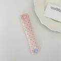 Details of pink polka dot cord organizer featuring cute heart and round snap buttons. - Light Pink Polka Dot