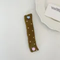 Close-up detail view of a cute fabric cable organizer with colorful heart and round buttons. - Olive Green Satin Polka Dot