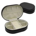 Compact oval PU leather jewelry box with soft beige velvet interior for rings and necklaces. - 14.5x9.5x4.5cm / Black