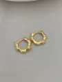 Detailed close-up of minimalist gold bamboo hoop earrings, elegant and chic jewelry design. - Bamboo Joint Style - Gold (Medium)