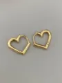 Close-up detail of minimalist gold heart hoop earrings showing polished metal surface. - Heart Style - Gold (Medium)