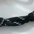 Schwarz-weißes geflochtenes Armbandkordel-Detail mit robustem Seil und sauberem Knoten. - Ankerkettenglied Strass Armband / Gold Schwarz