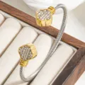 Twisted cable cuff bracelet with rhinestone clover ends, stylish metal jewelry for women. - Two-tone (Gold & Silver)