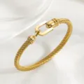 Bracelet manchette torsadé en acier titane doré, style luxe minimaliste élégant. - Or