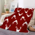 Red Christmas flannel blanket detail with white reindeer pattern, cozy sofa setting display. - ZM20250827-5