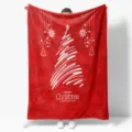Detailed view of red Christmas flannel blanket with white tree pattern and festive text. - MT06018-7