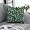 Detailed view of the dark green floral cushion cover, lifestyle scene on gray sofa couch. - ZB20250724-8