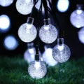 Close-up of glowing crystal bubble string lights, perfect for outdoor night garden decoration. - Solar 5m 20 LEDs 1.8cm Bubble Balls / Cool White