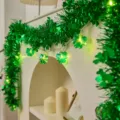 Green tinsel garland with clover LED string lights for St Patrick's Day party decor. - 2m 10-LED Battery Powered / Irish Shamrock Lights