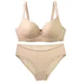 Detailed view of a comfortable nude bra and panty set with a delicate grid pattern and bow. - 75B / Apricot