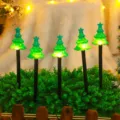 Solar Christmas tree ground stake lights detail view with glowing LED for outdoor garden decor. - Waterproof Battery Box - 8 Modes / Black Tube Christmas Tree (Set of 5)