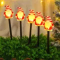 Close-up of glowing gnome garden stake lights with warm illumination in a festive lawn. - Waterproof Battery Box - 8 Modes / Black Tube Wizard (Set of 5)