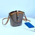 Elegante bolso bombonera de cuero con diseño en contraste, cadena de metal y correa. - Gris