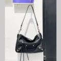Black leather motorcycle shoulder bag for women, featuring metal studs, zippers, and tassels. - 28*9*19 cm / Black