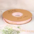 Pink grosgrain ribbon roll with gold foil love letters, ideal for gift wrapping and DIY crafts. - Width 1cm * Length 45 Yards / Pink