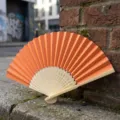 Orange folding hand fan with bamboo ribs for DIY crafts and wedding favors - Style P No.10 Hollow Carved Colored Paper Fan (Orange)