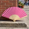 Elegant handheld pink folding fan with natural bamboo ribs for wedding favors and DIY craft - Style P No.11 Hollow Carved Colored Paper Fan (Rose Red)