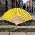 Blank bright yellow folding hand fan with hollowed bamboo ribs - Style P No.13 Hollow Carved Colored Paper Fan (Lemon Yellow)