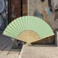Light green folding hand fan with natural bamboo ribs for wedding favors and DIY craft - Style P No.14 Hollow Carved Colored Paper Fan (Light Green)