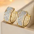 Close-up detail of vintage two-tone gold and silver filigree hoop earrings with cut-out design. - Two Colors