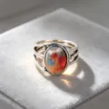 Close-up of vintage silver ring with multi-color oval stone, intricate hollow multi-layer band. - Size 6 / Silver